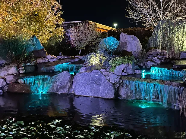Waterfall with teal LED lighting at night